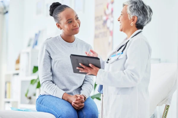 doctor-women-tablet-happy-healthcare-hospital-news-support-with-test-results-exam-bed-senior-nurse-patient-with-digital-registration-clinic-sign-up-medical-consultation